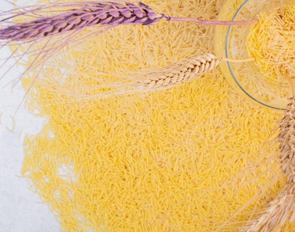 Little yellow vermicelli with vase of wheats . High quality photo